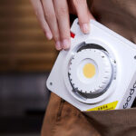 Product photo of Godox ML100Bi LED being slid into someone's pocket