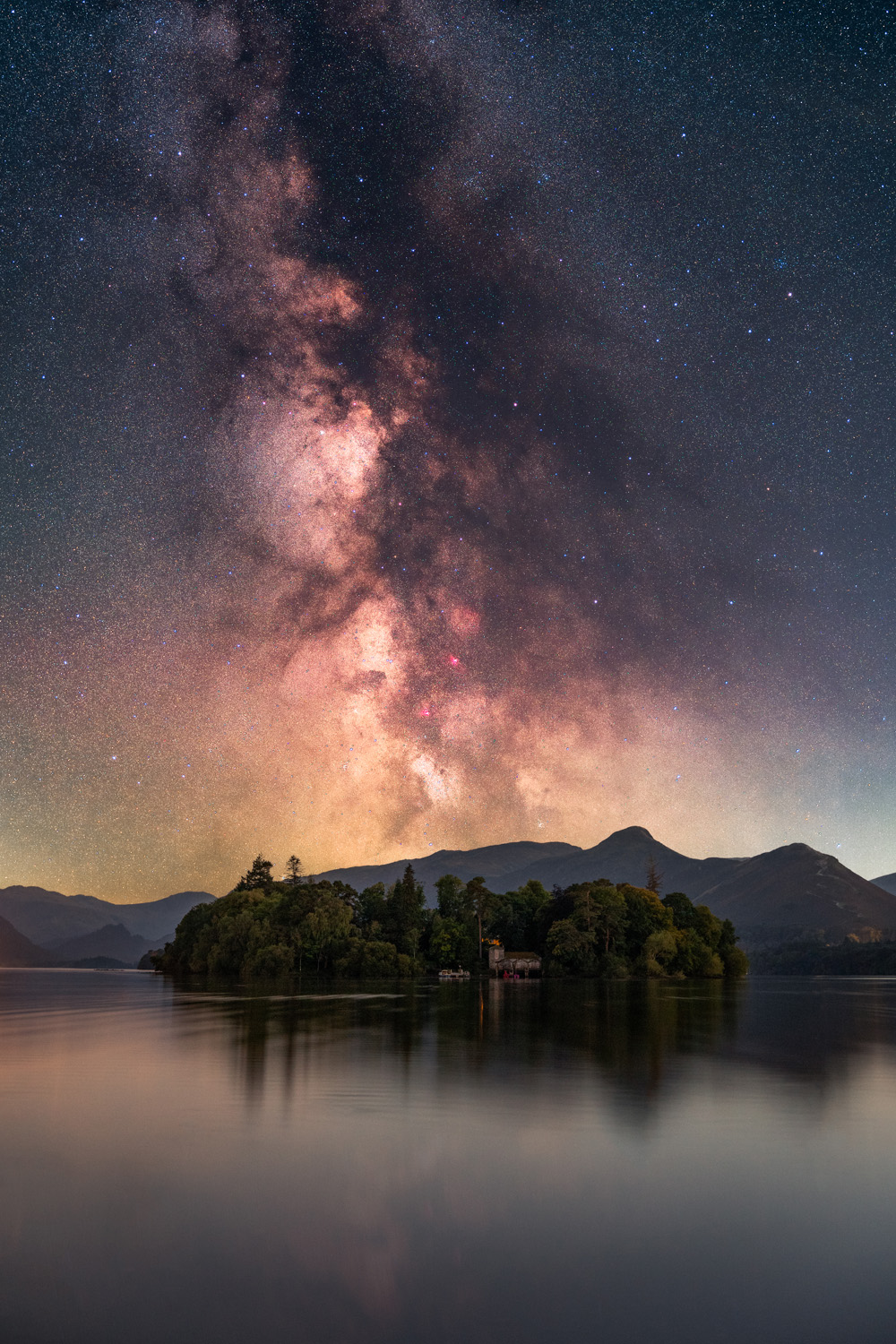 Astro photography image of the milky way rising above a lake